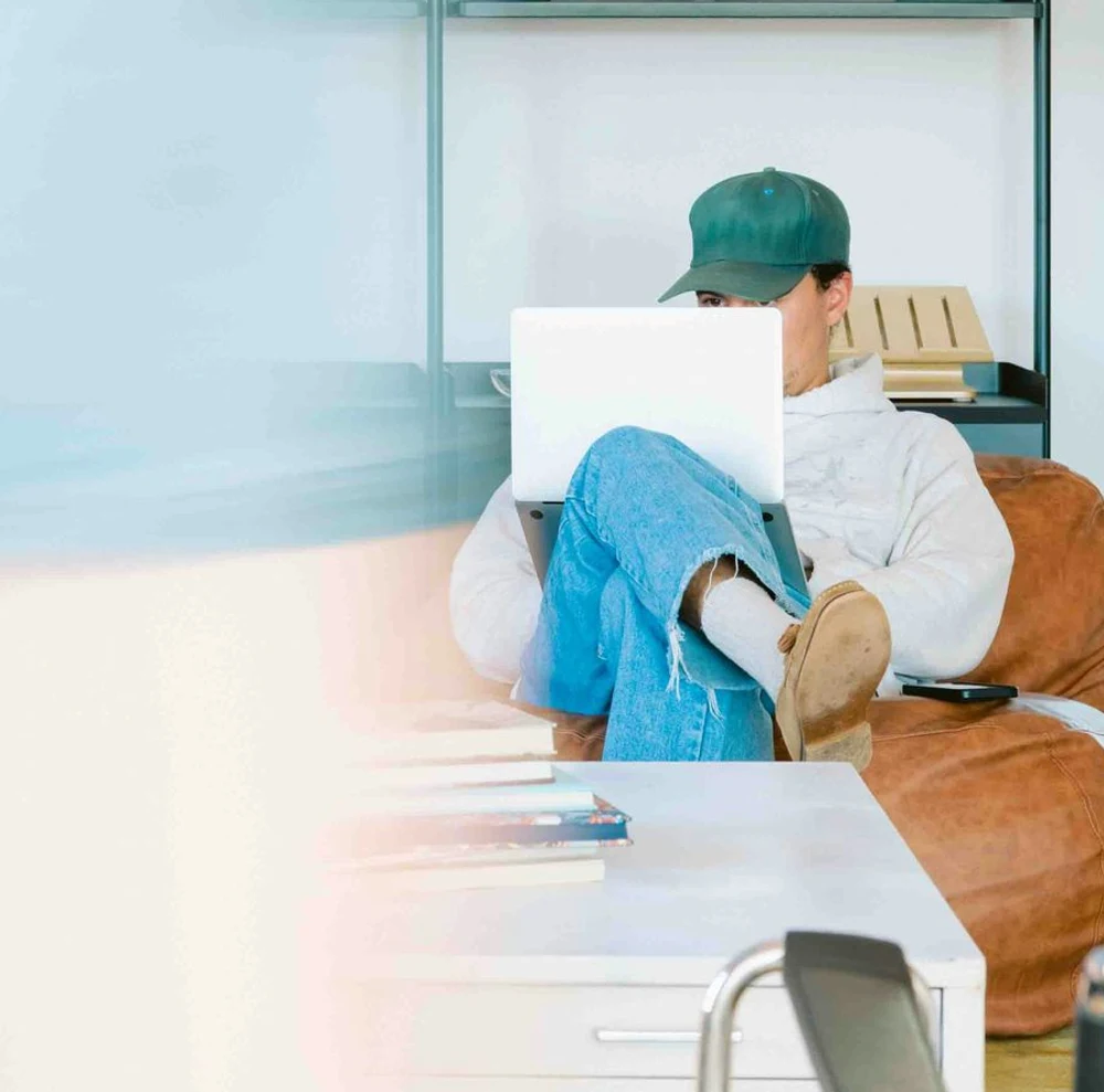 Agency worker reading at a desk beside a window