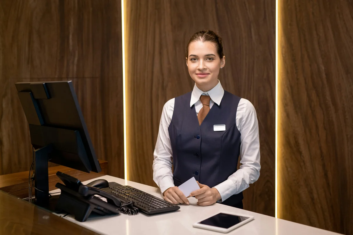 Hotel front desk receptionist at a check-in counter